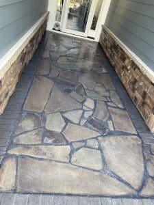 Freshly painted Charleston SC home exterior with gray siding, stone-veneer walls, and flagstone walkway