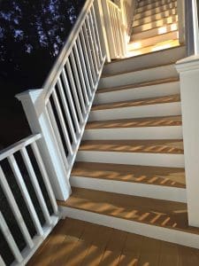 Freshly painted Charleston SC exterior deck stairs with white railings and natural wood treads