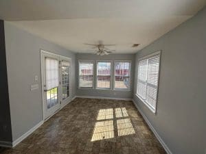 Freshly painted Charleston SC sunroom with light gray walls, white trim, and tile flooring