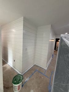 Charleston SC interior painting project with freshly painted white shiplap walls and floors masked for protection