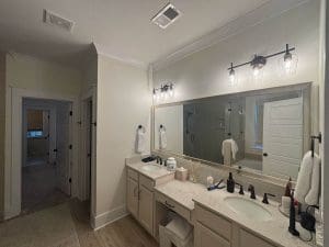 Freshly painted Charleston SC bathroom with soft greige walls, double vanity, and large framed mirror