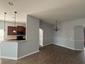 Freshly painted Charleston SC open kitchen and dining area with gray walls and white chair rail trim
