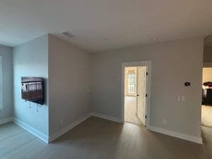 Freshly painted Charleston SC living room with soft gray walls, white trim, and hardwood floors