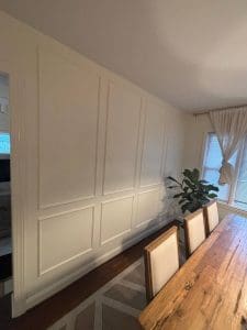 Freshly painted Charleston SC dining room with cream walls and white picture-frame wainscoting