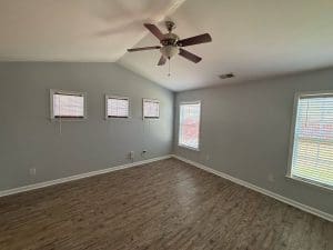 Freshly painted Charleston SC bedroom with gray walls, vaulted ceiling, and white trim