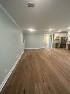 Freshly painted Charleston SC open-concept living space with soft blue walls and white trim
