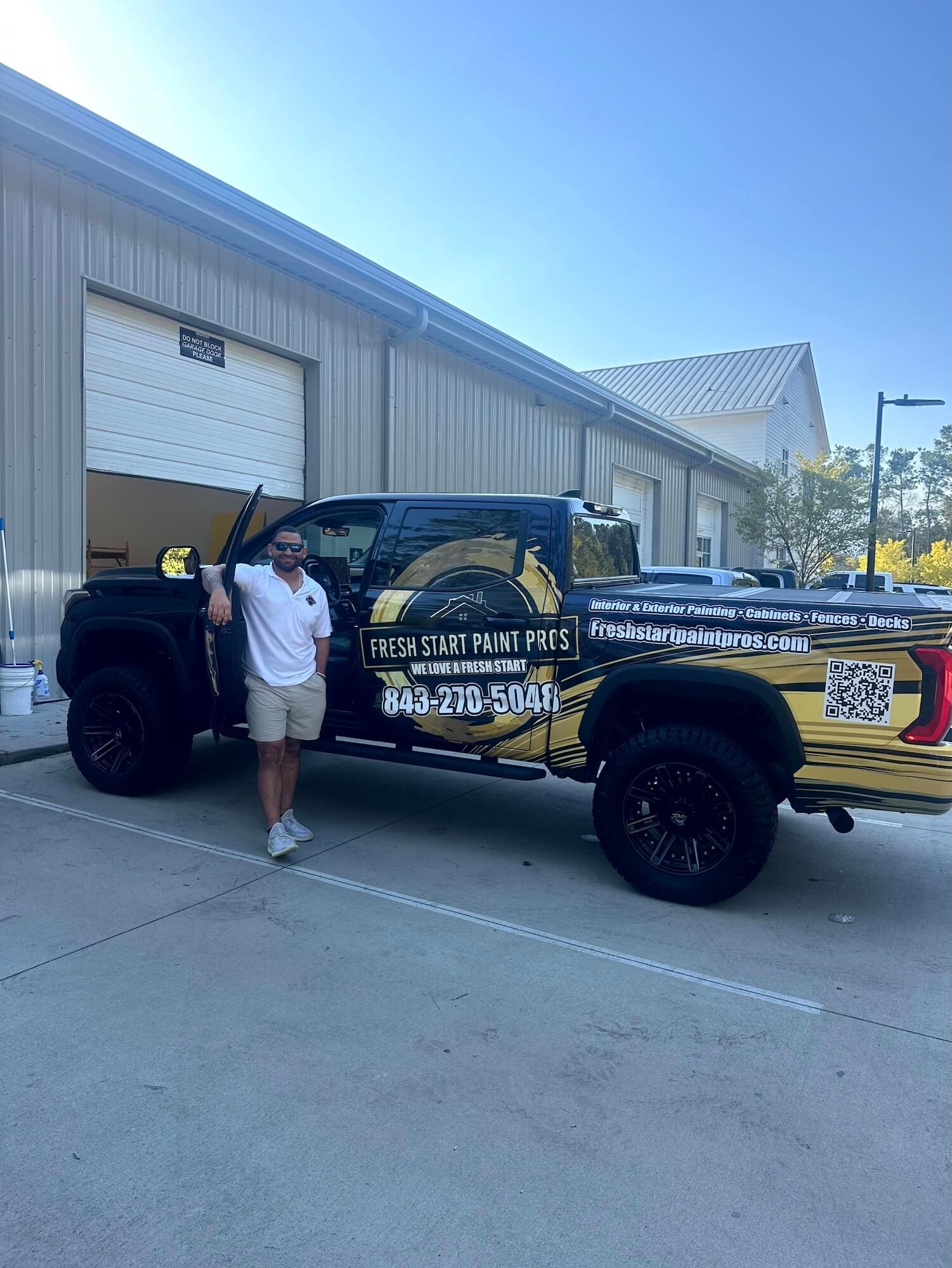 fresh start paint pros owner Humberto Machin in front of branded truck