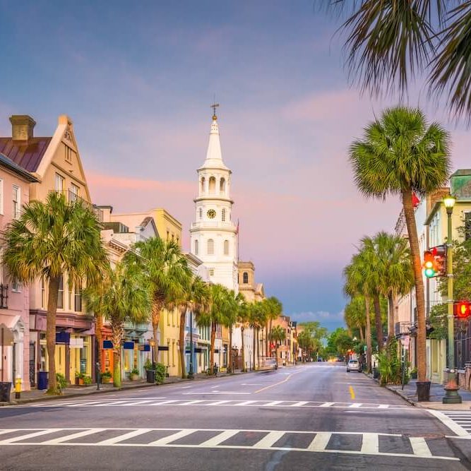 Colorful historic homes and church steeple along Church Street in downtown Charleston, South Carolina — a preserved neighborhood where lead paint may still be present in older homes.